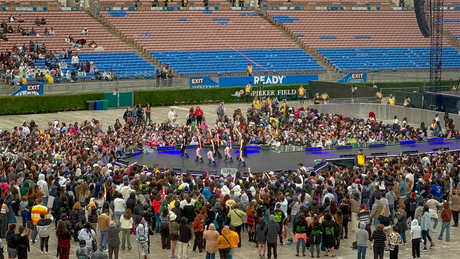 Momoland dancing during the rain at the fan stage.
