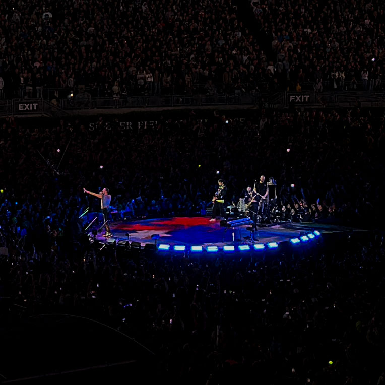 Coldplay performing at the Rose Bowl during the 2023 Music of the Spheres tour.