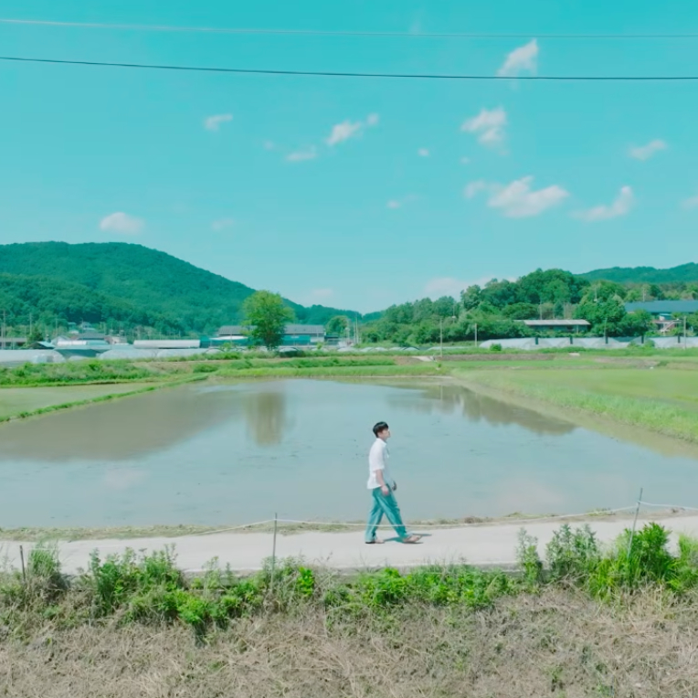 Still from Minhyuk's music video for his single, "Reaching."